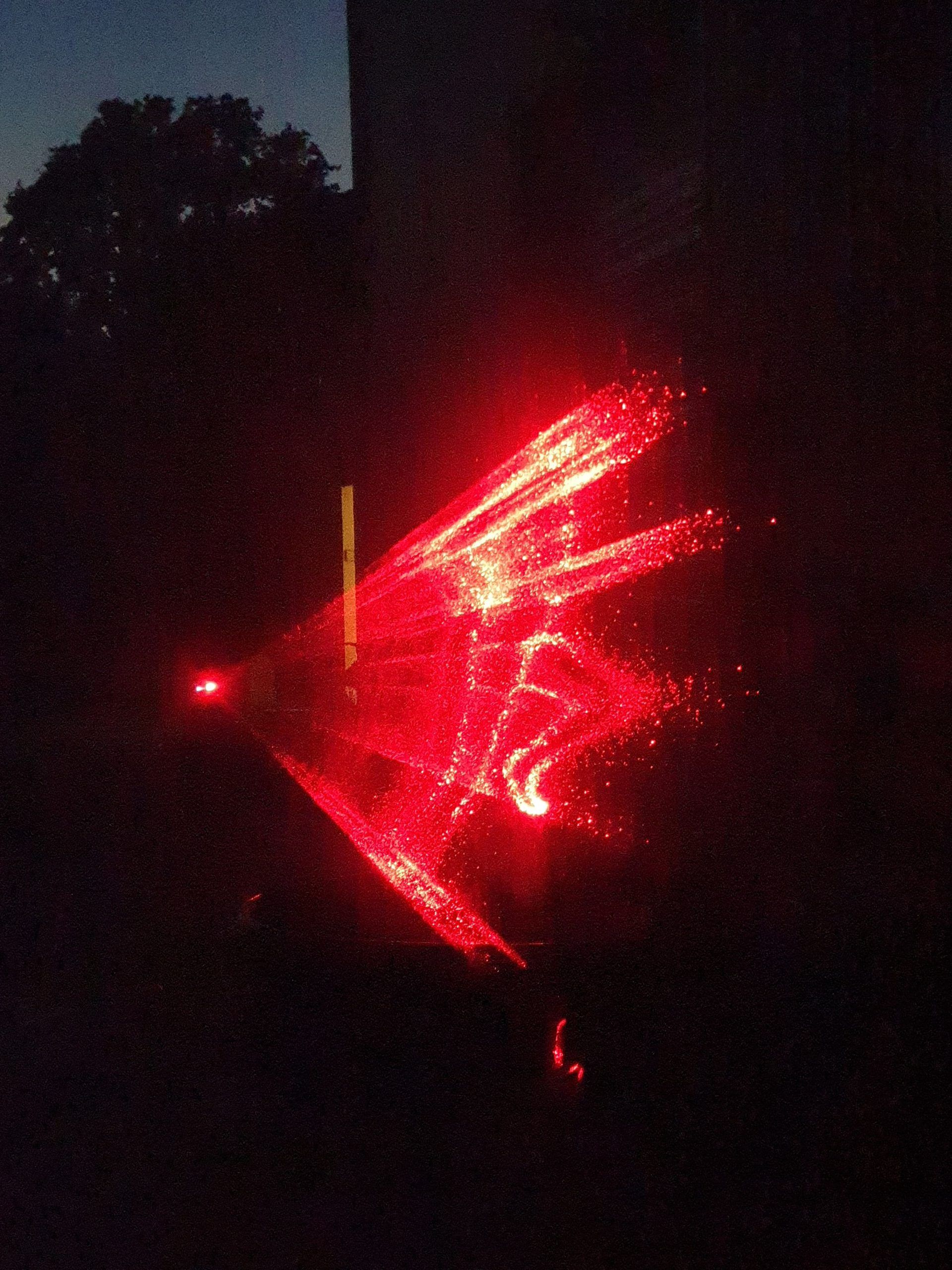 Photo of a man running projected with red lasers