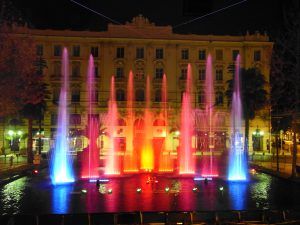 Photo of a pond with blue, pink and orange water jets