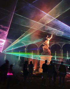 Photo of the bosquet des colonnades in Versailles with lasers projected around the statue in the middle