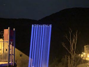 Photo of a mountain with the word welcome projected onto it