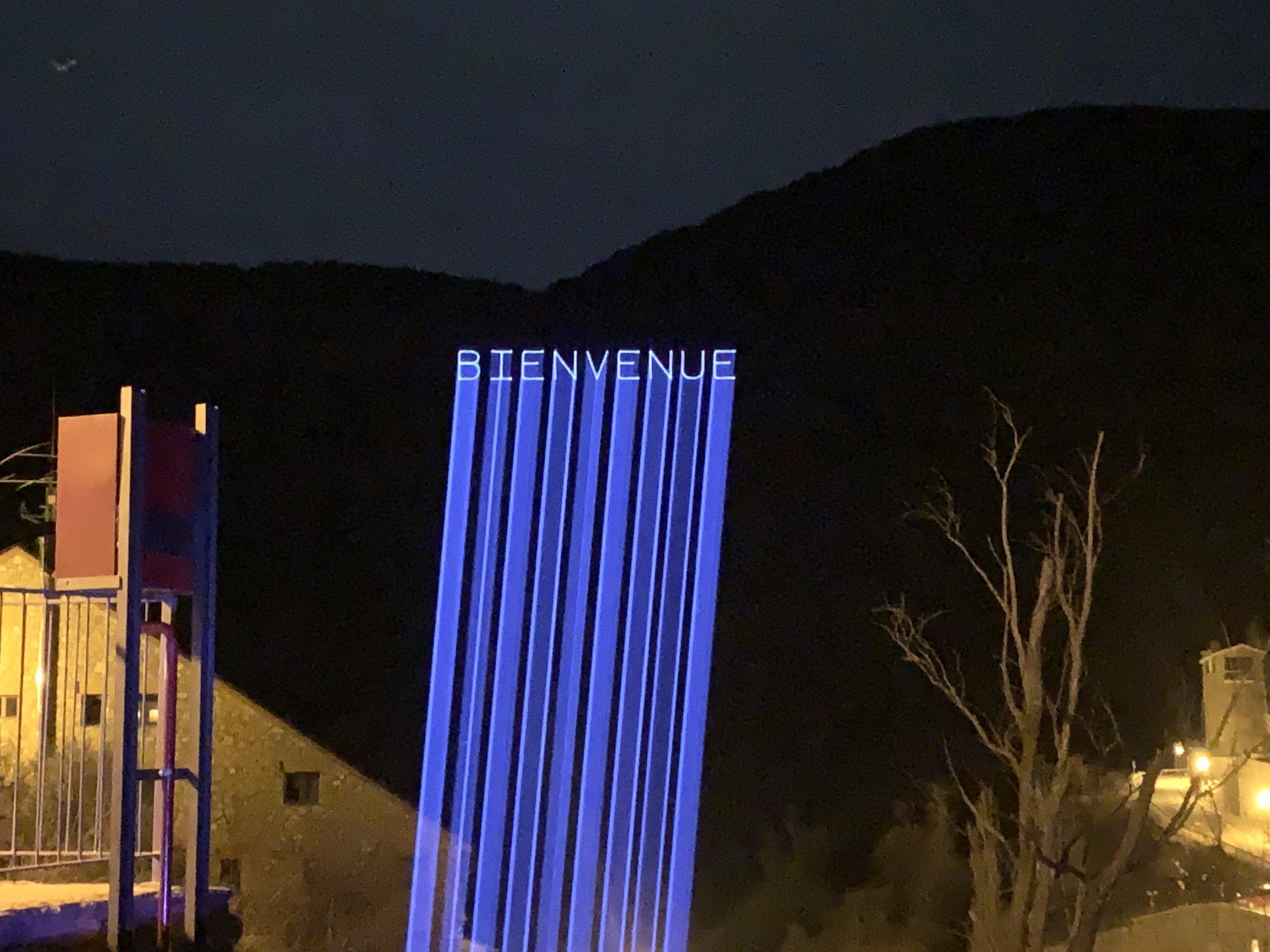 Photo of a mountain with the word welcome projected onto it