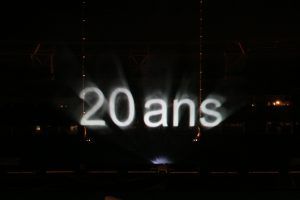 Photo of a text 20 years projected on a screen of water