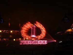 Photo of a 1 premiere logo projected onto a water screen in red