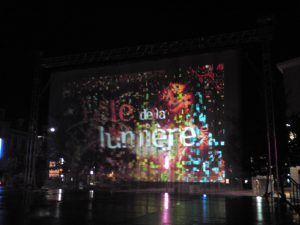 Photo of a water curtain with a light festival projected on it