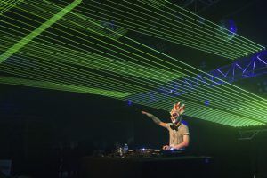 Photo of a DJ with laser bars projected above him