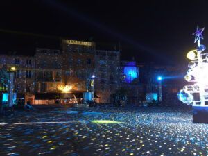 Town square illuminated by a tree made up of disco balls