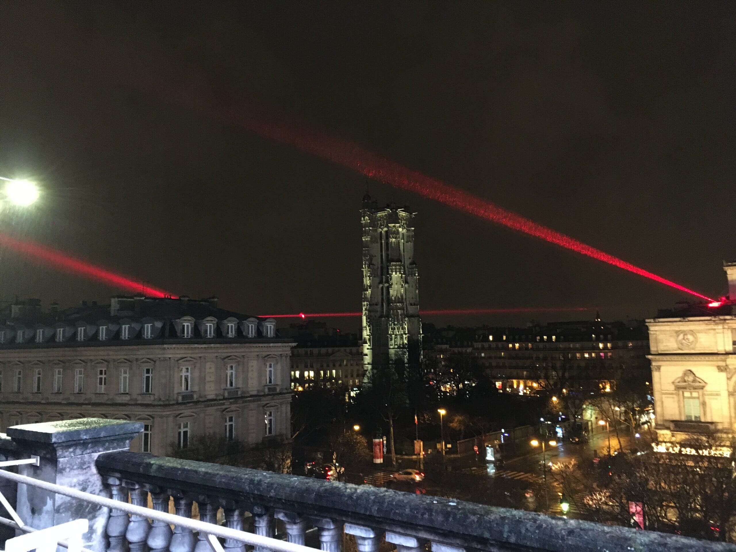 Europe Évènement - Laser show - Photo of red laser beams passing around a church representing a red triangle