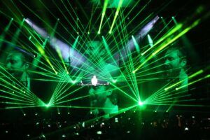 Europe Évènement - Show festival - Photo of a DJ David Guetta concert with green laser beams around him